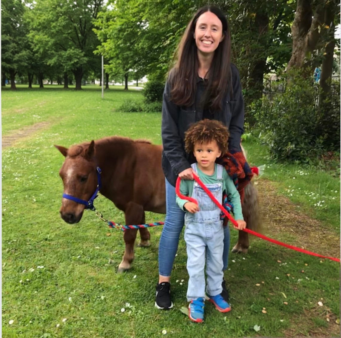Child standing with Easter Pony.