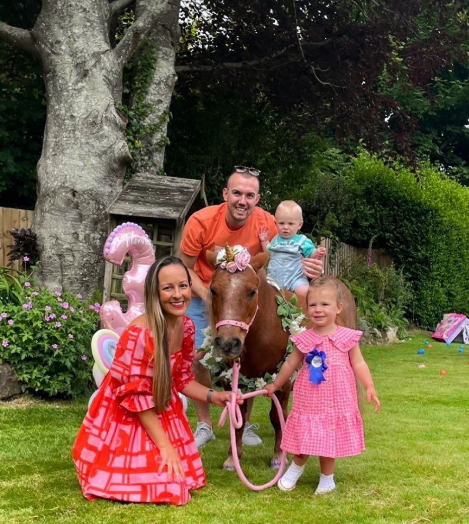 2 children with a pony at their party at home.