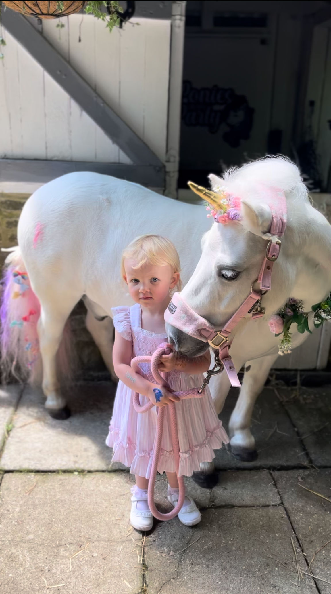 Child standing with Easter Pony.